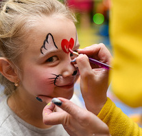 The animator paints the face of the child.